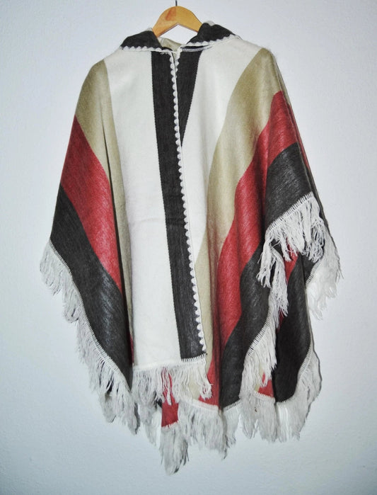 Handmade alpaca wool hooded poncho with white, red, beige, and black stripes and fringe trim.