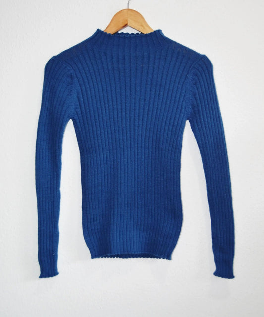 Handmade blue alpaca turtleneck sweater with ribbed knit texture and long sleeves.