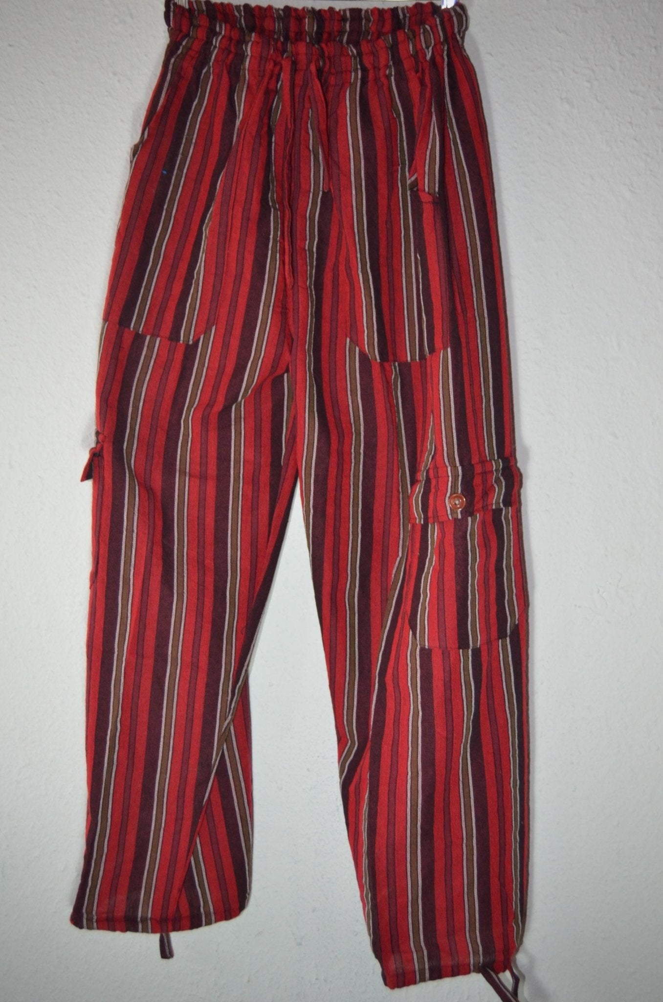 Handmade alpaca hippie pants with red and black vertical stripes and cargo pockets.