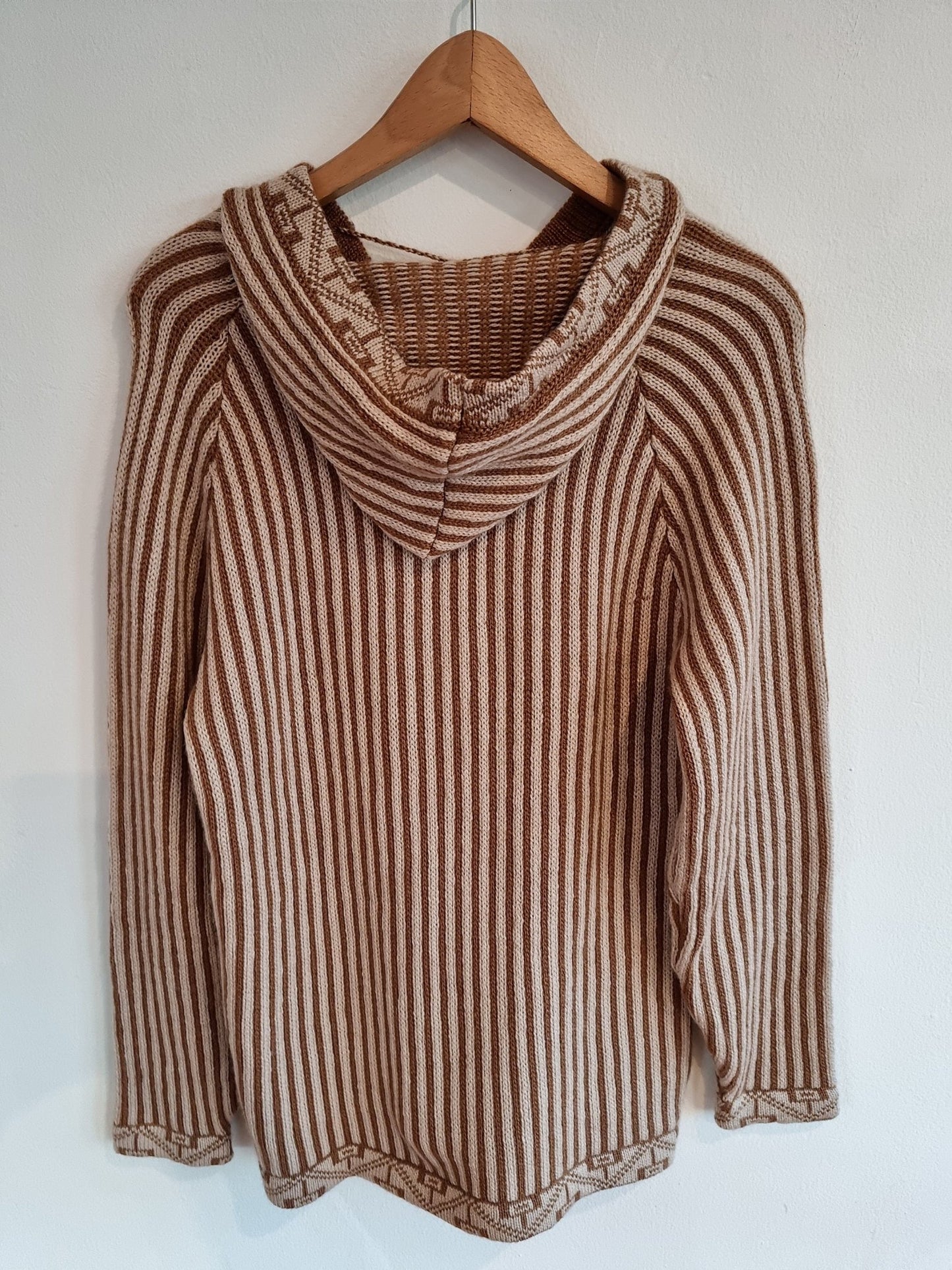 Handmade alpaca sweater in brown and beige stripes with a hood and long sleeves.
