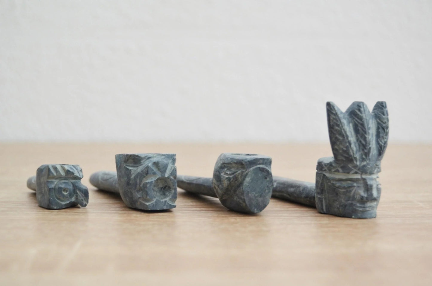Handmade carved stone pipe with alpaca detail and intricate Andean-inspired designs.