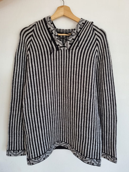 Handmade alpaca wool sweater with black and white vertical stripes and lace-up neckline.