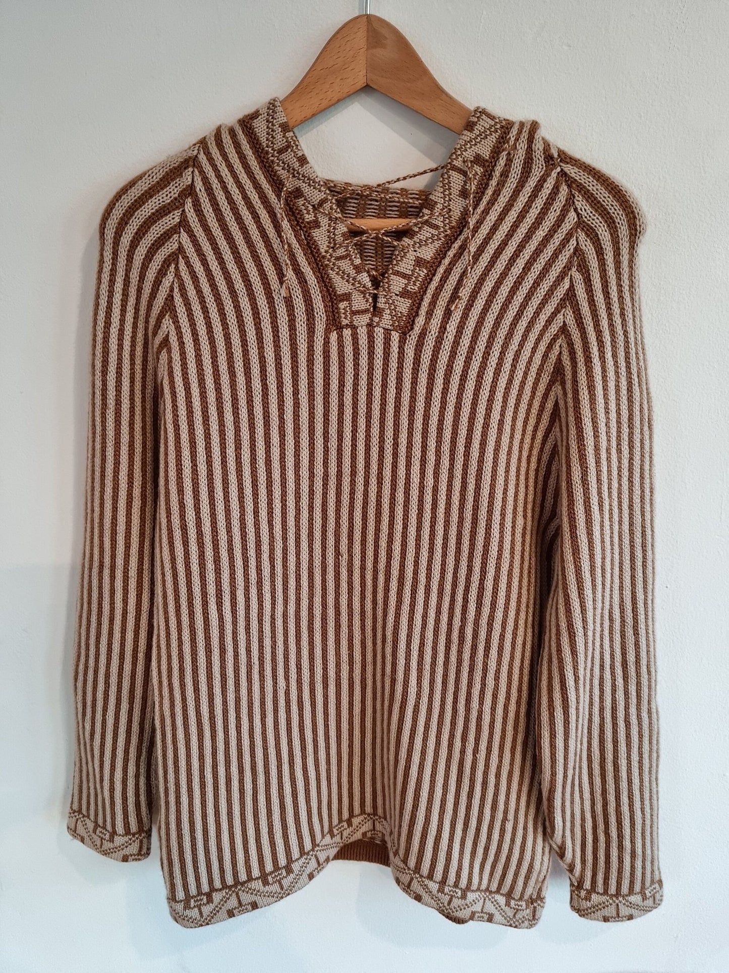 Handmade brown and beige striped alpaca wool sweater with lace-up collar and long sleeves.