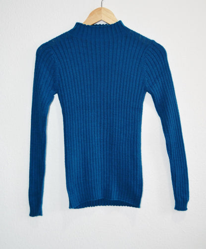 Handmade blue alpaca turtleneck sweater with ribbed knit and long sleeves.