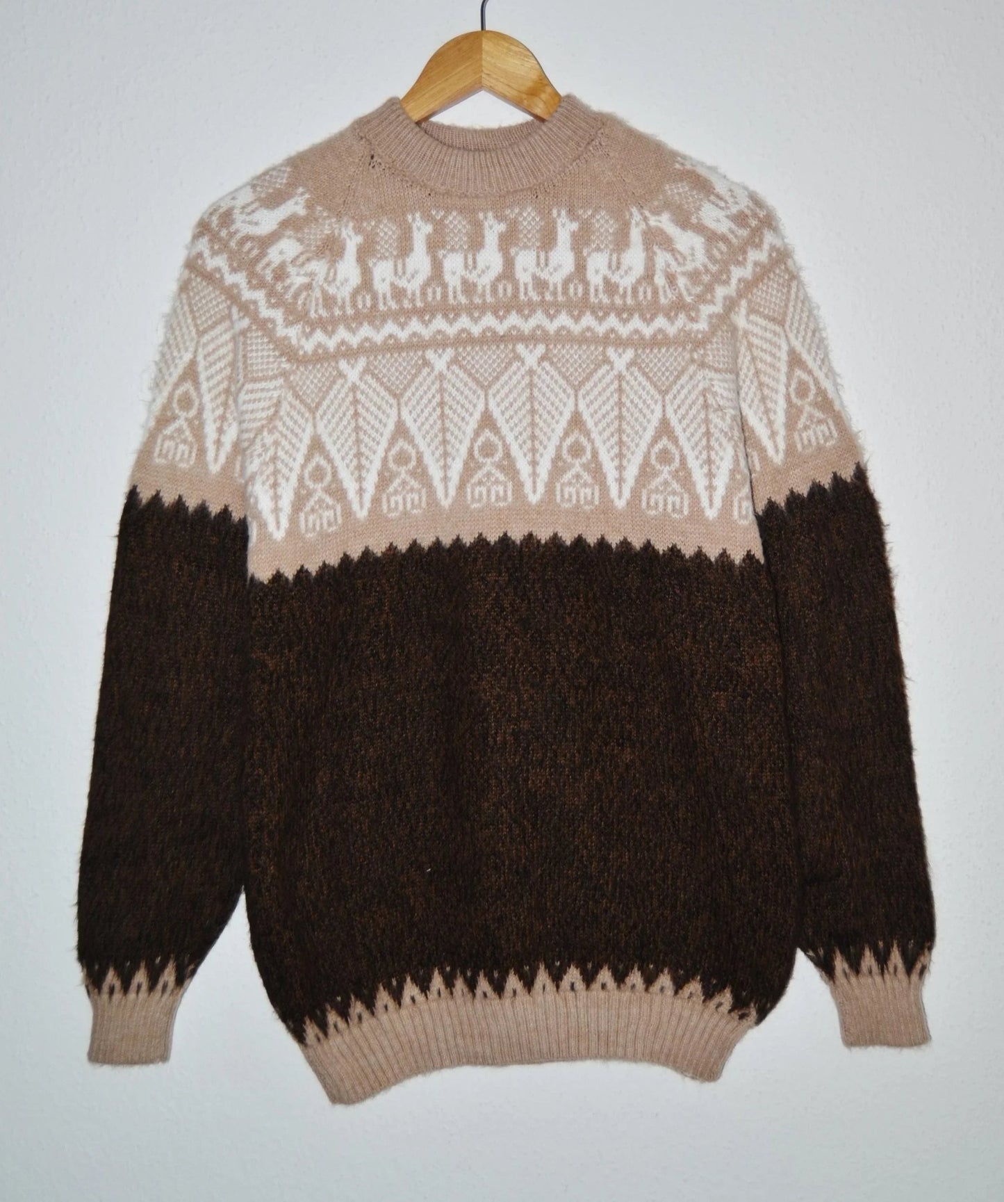 Handmade alpaca sweater with beige and dark brown geometric pattern and high collar.