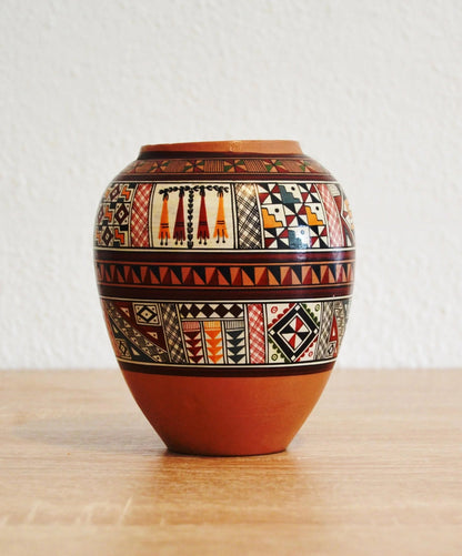 Handmade terracotta jar with intricate traditional Andean patterns and alpaca motifs.