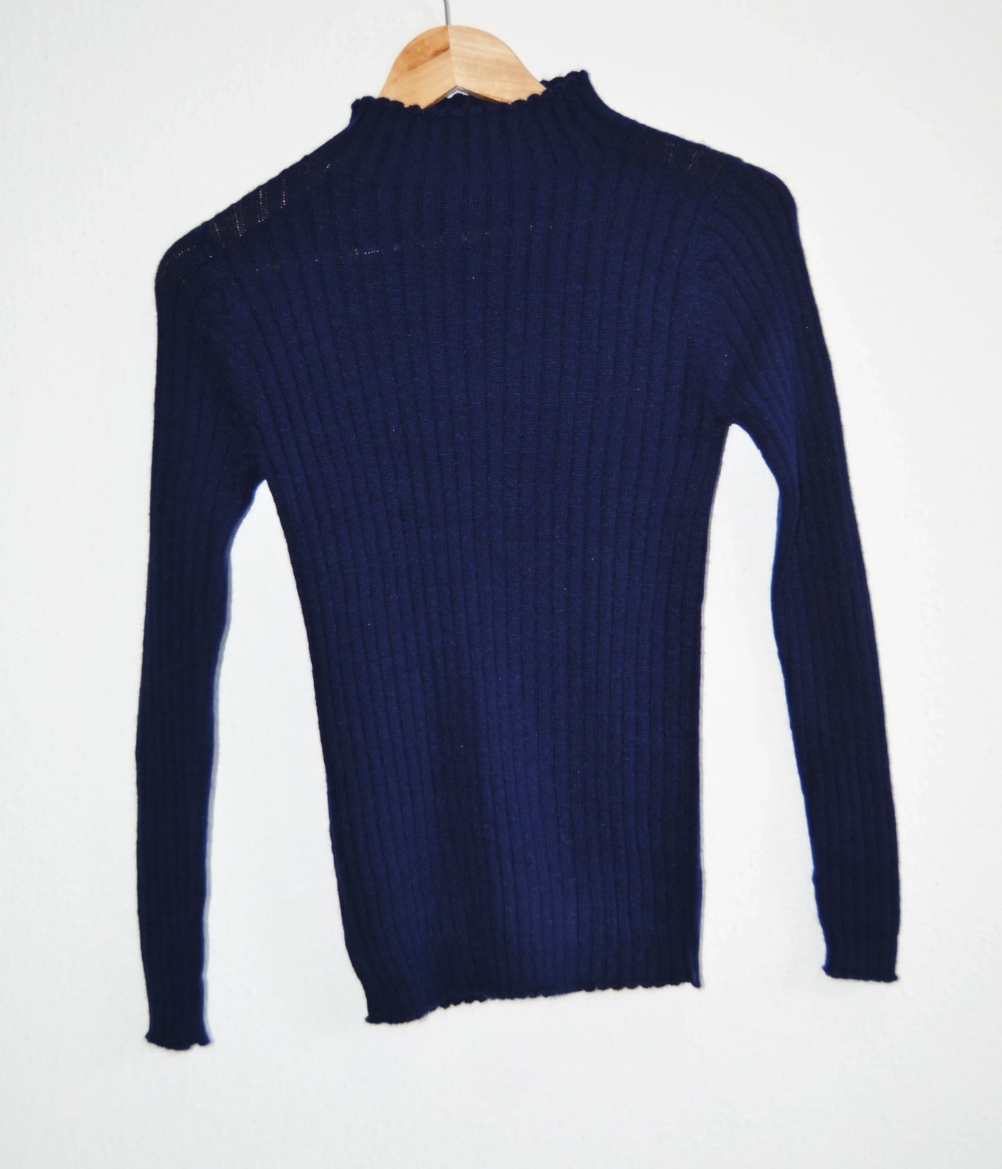 Navy blue handmade alpaca turtleneck sweater with ribbed knit pattern.