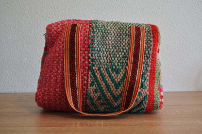 Handmade alpaca wool shoulder bag with colorful geometric patterns and striped handles.