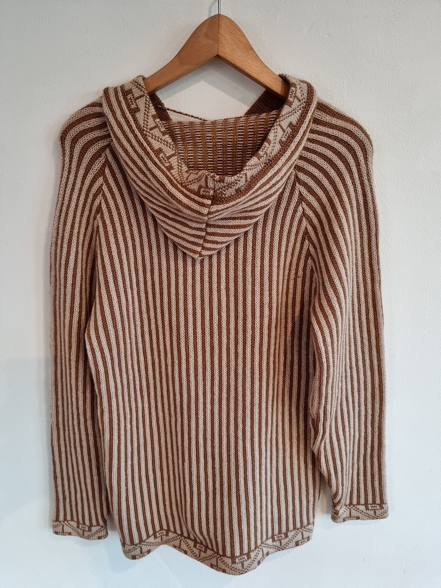 Handmade alpaca sweater in brown and beige stripes with a hood and long sleeves.