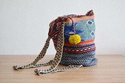 Colorful handmade alpaca shoulder bag with intricate geometric patterns and woven strap.