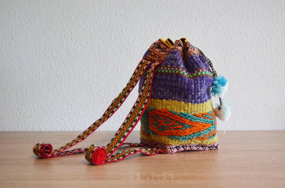 Handmade colorful alpaca shoulder bag with traditional Peruvian patterns and braided straps.
