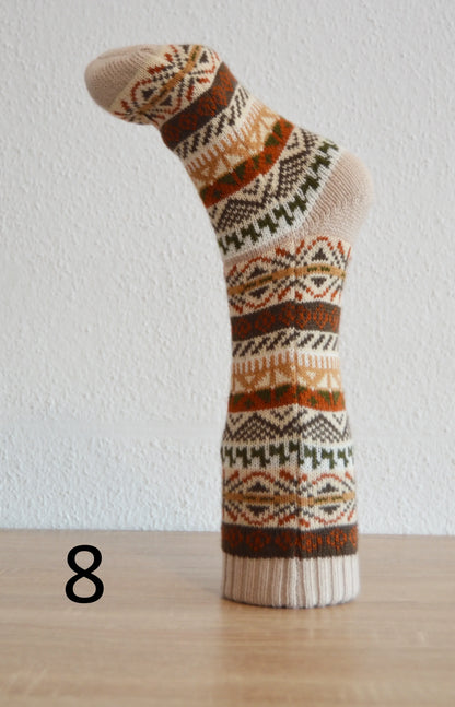 Handmade alpaca wool sock with geometric patterns in brown, orange, and cream tones.