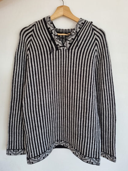 Handmade alpaca wool sweater with black and white vertical stripes and lace-up neckline.