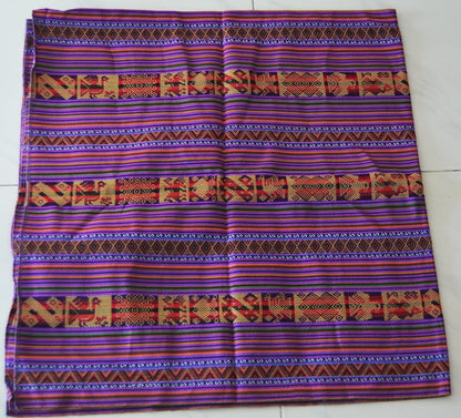 Handmade alpaca blend mestana cloth with vibrant purple, red, and orange Andean geometric patterns.