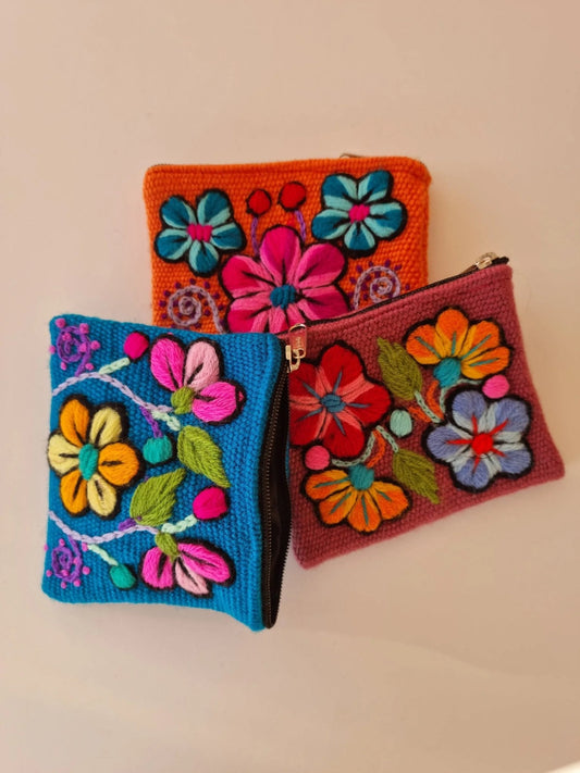 Handmade alpaca wool wallets in orange, blue, and red with vibrant floral embroidery and ethnic design.