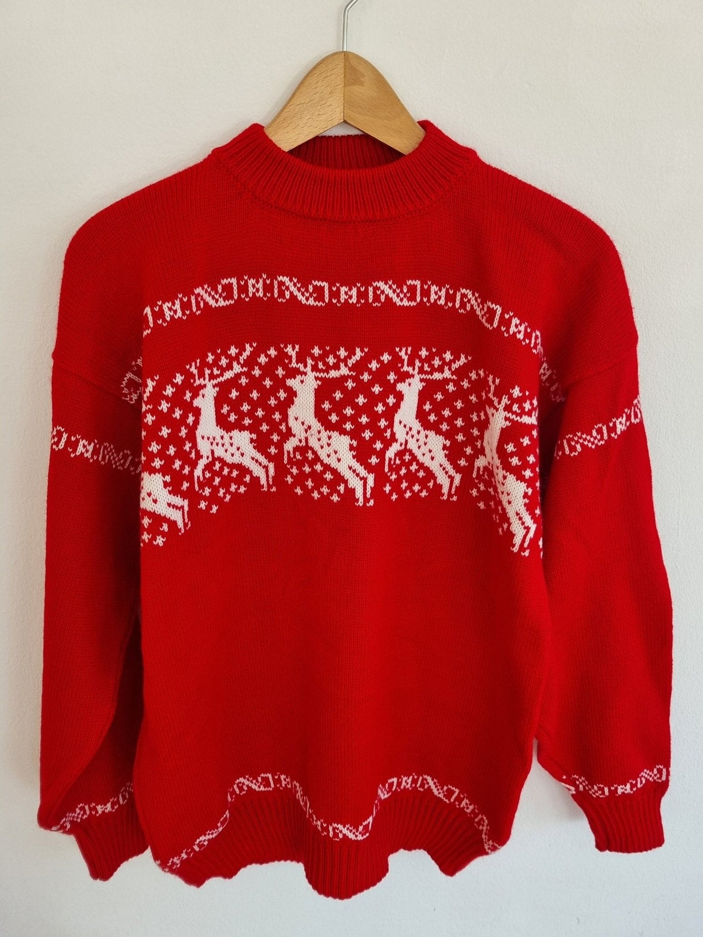 Handmade red alpaca sweater with white reindeer and geometric patterns, unisex style.