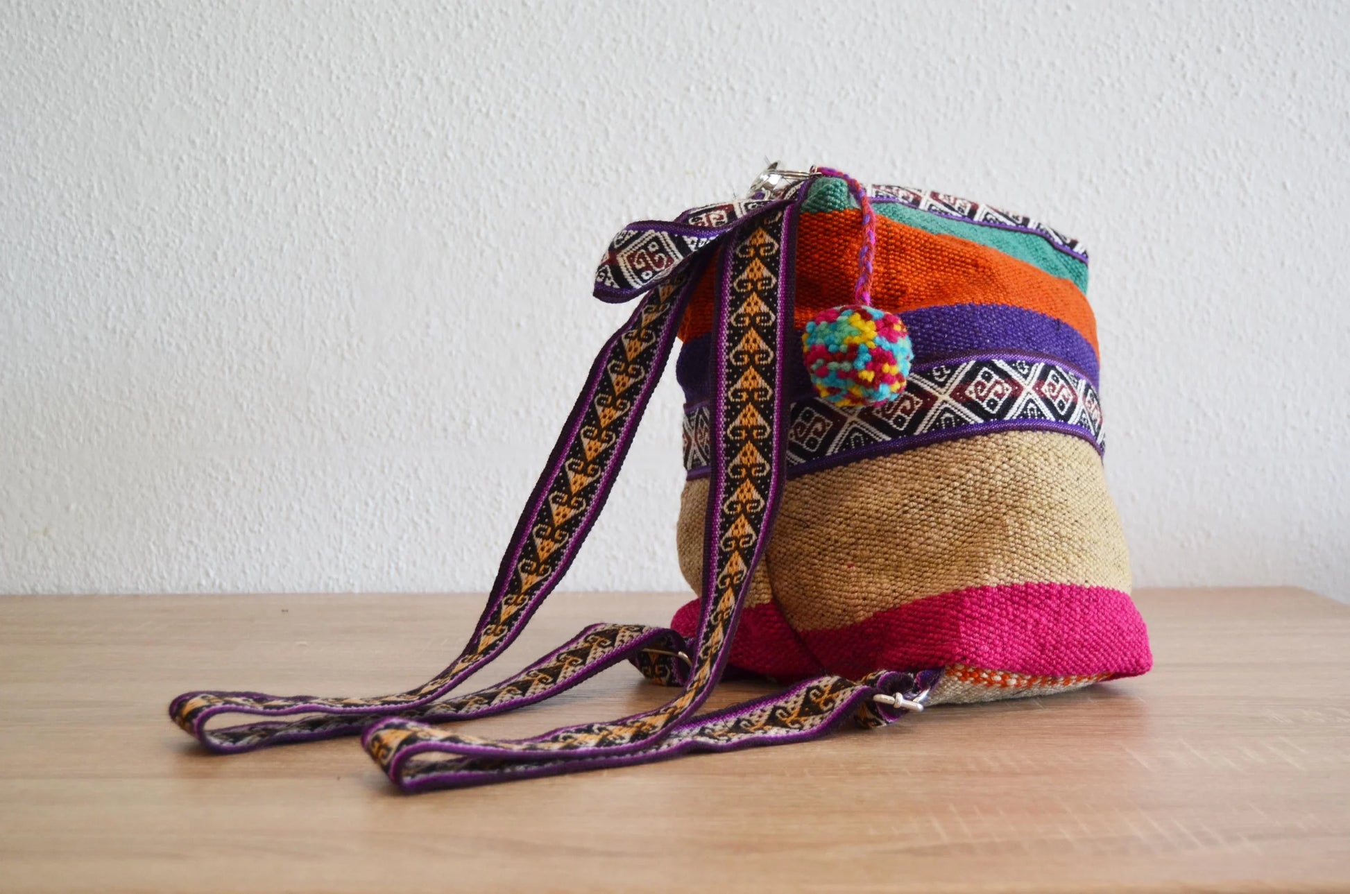 Handmade alpaca shoulder bag with colorful stripes and traditional Peruvian patterns.